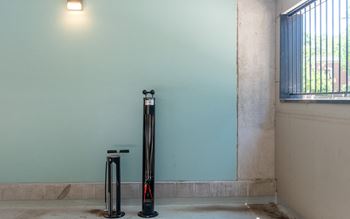 three scooters parked next to a wall in a room